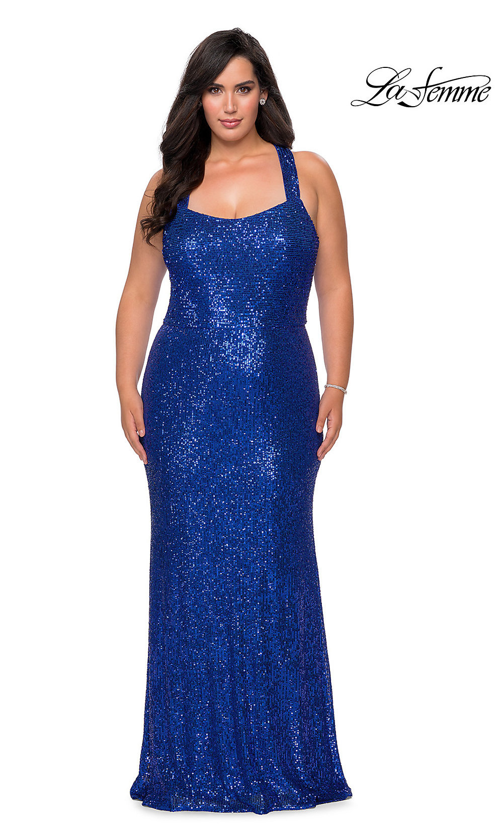 A woman poses in a royal blue La Femme Plus-Size Sequin X-Back Long Prom Dress against a white background with the